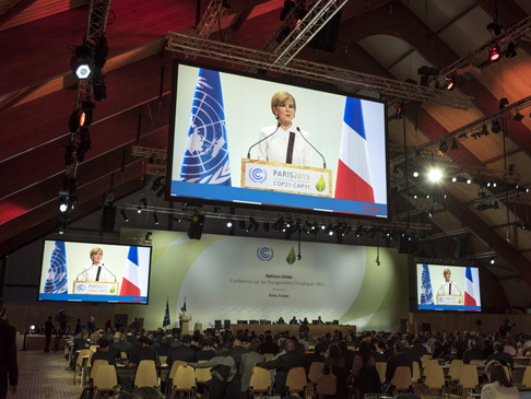 Minister Bishop on a large screen, speaking to COP21