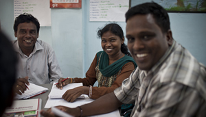 Smiling adults seated at table