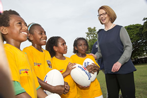 Photo of Prime Minister Julia Gillard and 4 children holding balls