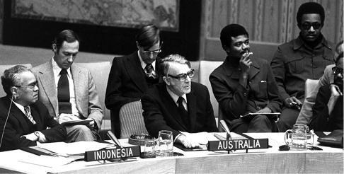 The Australian Permanent Representative to the United Nations, Ralph L Harry (centre), presents Australia's statement during the UN Security Council consideration of question of Portuguese Timor, New York, 16 December 1975. Left, Chaidir Anwar Sani (Indonesia); and right, Rashleigh Esmond Jackson (Guyana). [UN Photo/T Chen]