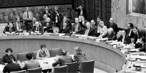 The Australian Permanent Representative to the United Nations, Richard A Woolcott (right), presides in the UN Security Council as UN officials (lower right) oversee voting, New York, 15 November 1985. Seated (left to right): Guennadi I Oudovenko (Ukrainian SSR); Oleg A Troyanovsky (Soviet Union); Sir John Thomson (United Kingdom); Herbert S Okun (United States); and UN Secretary-General Javier Pérez de Cuéllar. [UN Photo/Milton Grant]