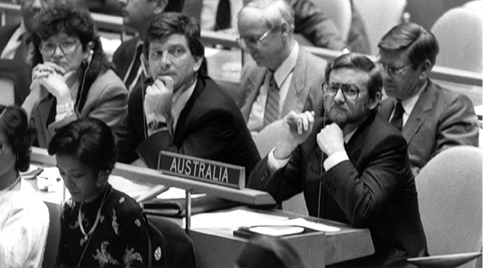 The Australian Minister for Foreign Affairs, Senator Gareth J Evans (right), with the then acting Permanent Representative to the United Nations, Michael J Costello (centre), New York, 4 October 1988. [UN Photo/Yutaka Nagata]