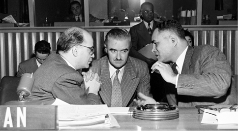 The Argentine Permanent Representative to the United Nations and Chairman of the Fourth (Trusteeship) Committee, Rodolfo Muñoz (left), confers with the Chairman of the Trusteeship Council-appointed visiting mission to West Africa, Roy Peachey (Australia) (centre), and the Secretary of the Committee and Principal Director of the UN Department of Trusteeship and Information from Non-Self-Governing Territories, Dr Ralph Bunche, before the meeting of the Fourth Committee, Seventh Session of UN General Assembly