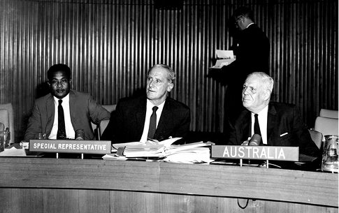 The Australian Special Representative of the Joint Administering Authority (Australia, New Zealand and the United Kingdom), Dudley McCarthy (centre), is questioned by representatives in the Trusteeship Council on conditions in the trust territory of Nauru, New York, 27 June 1961. Adviser to the Australian Representative, Raymond Gadabu of Nauru (left); and Minister, Australian Permanent Mission to the United Nations, John DL Hood (right). [UN Photo/MB]