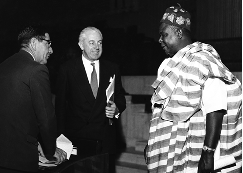 The Australian Minister for Labour and National Service, Harold Holt (centre), and the past president of the Hobart Trades Hall Council, AJ White (left), exchange views with the Nigerian Minister for Labour and Welfare, Sam Okotie-Eboh, at the ILO Conference, Geneva, 1957. [National Archives of Australia]