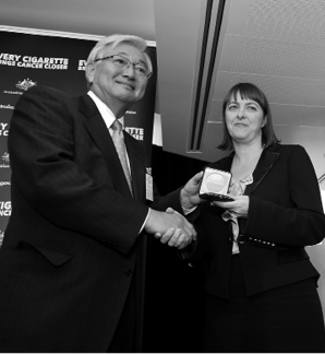 The Australian Minister for Health and Ageing, Nicola Roxon (right), receives the WHO Director-General's Special Recognition Award for the Australian government's proposal to introduce plain packaging to tobacco products in 2012 from the WHO Regional Director for the Western Pacific, Dr Shin Young-soo, Manila, 31 May 2011. [Department of Health and Ageing]