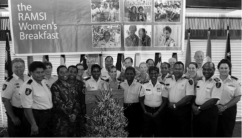 The Australian Commander of the Regional Assistance Mission Solomon Islands Participating Police Force, AFP Commissioner Wayne Buchhorn (back right), the acting Commissioner Royal Solomon Islands Police Force, Walter Kola (front, third right), and Deputy Commissioner Eddie Sikua (front, second right), with officers of the Participating Police Force and soldiers from the Combined Task Force, celebrate International Women's Day with local community women, Honiara, 2 March 2011. [Department of Defence