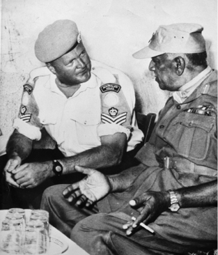 An Australian police officer from New South Wales, Sergeant Robert Macdonald (left)—a member of the UN Civilian Police attached to the UN Force in Cyprus—talks with the force commander, General Kodendera Thimayya (India), during the commander's tour of peace force units, 1965. [New South Wales Police]