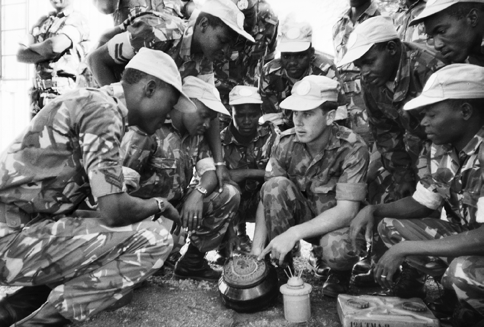 An Australian field engineer serving with the UN Transition Assistance Group (UNTAG), Sapper Robert Wickham (centre), conducts mine awareness training for Kenyan battalion engineers at Okahandja, Namibia, June 1989. [Australian War Memorial]