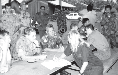 The Australian Force Commander, UN Transitional Authority in Cambodia (UNTAC), Lieutenant-General John Sanderson (second left), and the commander of the Malaysian contingent, Colonel Arshad Md Raji (centre), discuss plans for the conduct of the election with an UNTAC election supervisor, Battembang, 1992. [John Sanderson]