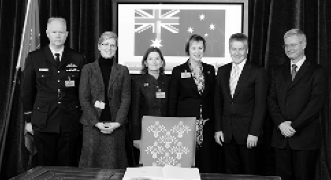 The Australian Minister for Foreign Affairs, Stephen Smith (second right) signs the Convention on Cluster Munitions, Oslo, 3 December 2008. Left to right: the head of the Australian Defence Staff, London, Air Commodore Steve Martin; acting Adviser Minister's Office, Rachel Moseley; the Australian Ambassador to Norway, Sharyn Minahan; the Australian Ambassador for Disarmament, Caroline Millar; Stephen Smith; and the Assistant Secretary-General UN Office of Legal Affairs, Peter Taksøe-Jensen. [Department of 