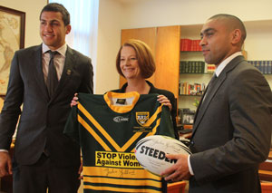 Prime Minister Julia GIllard holding a signed rugby jersey