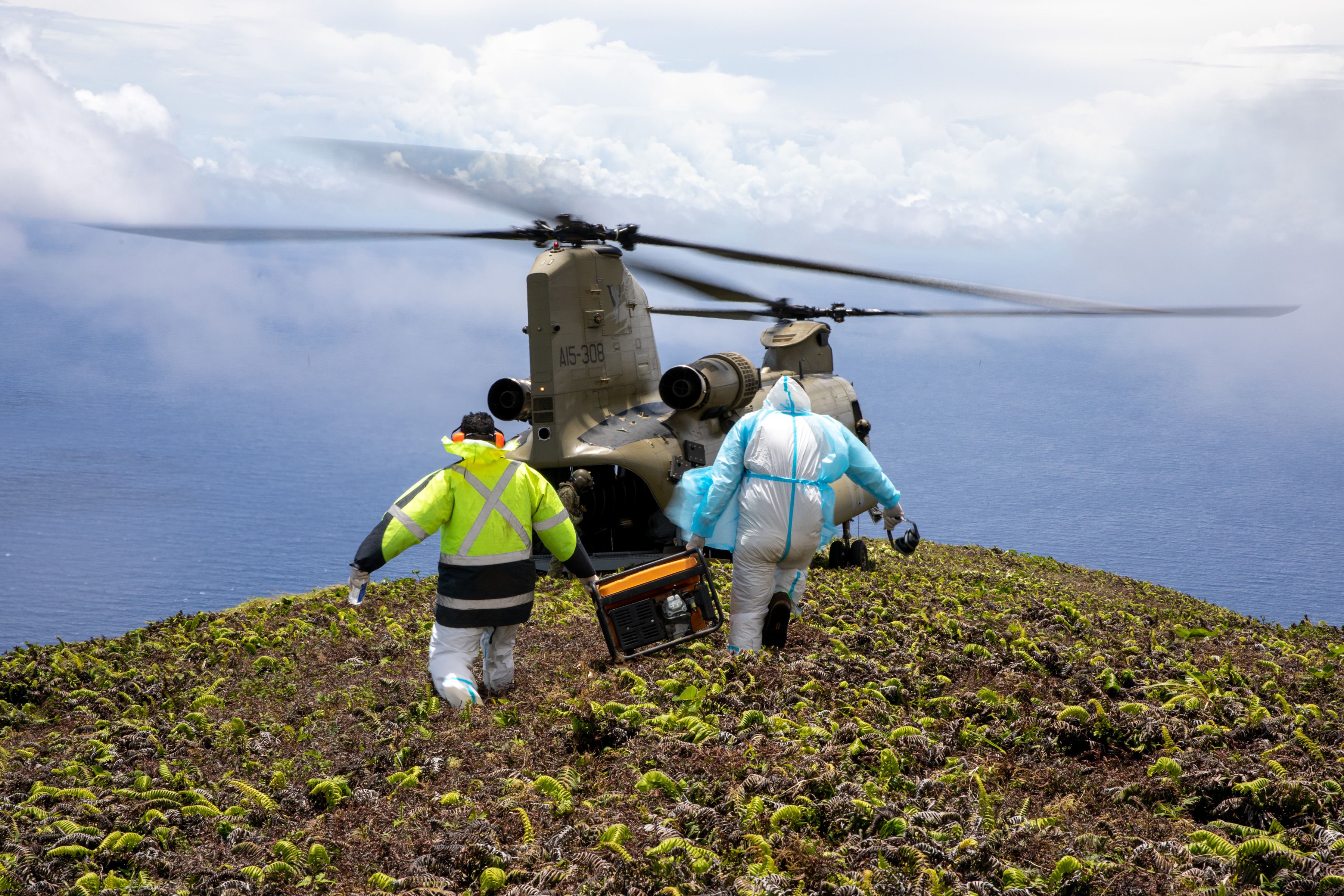 Tongan Technicians prepare to board helicopter