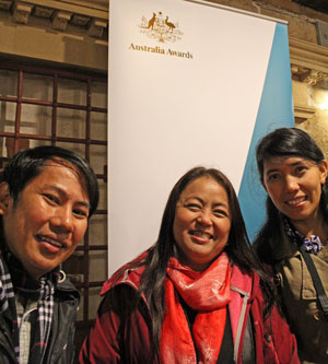 Three young adults smiling