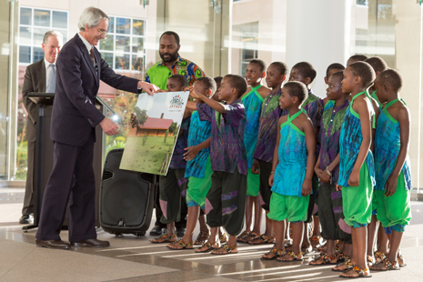Deputy Secretary Ric Wells accepting a painting from children as a gift