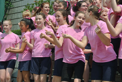 Members of the Australian Girls Choir singing and dancing in Hong Kong.