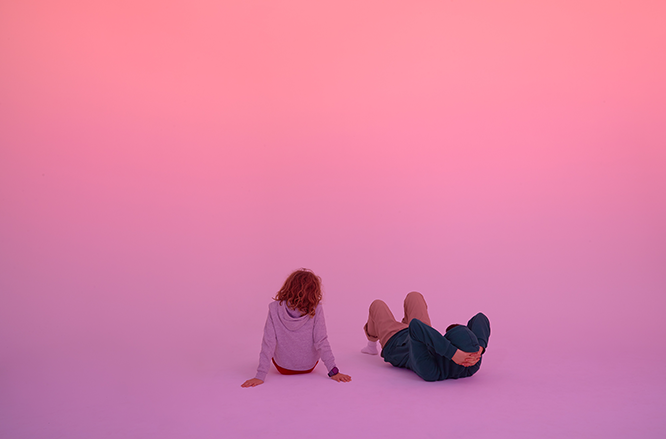 Two people in a pink environment