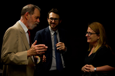 Three people standing, talking