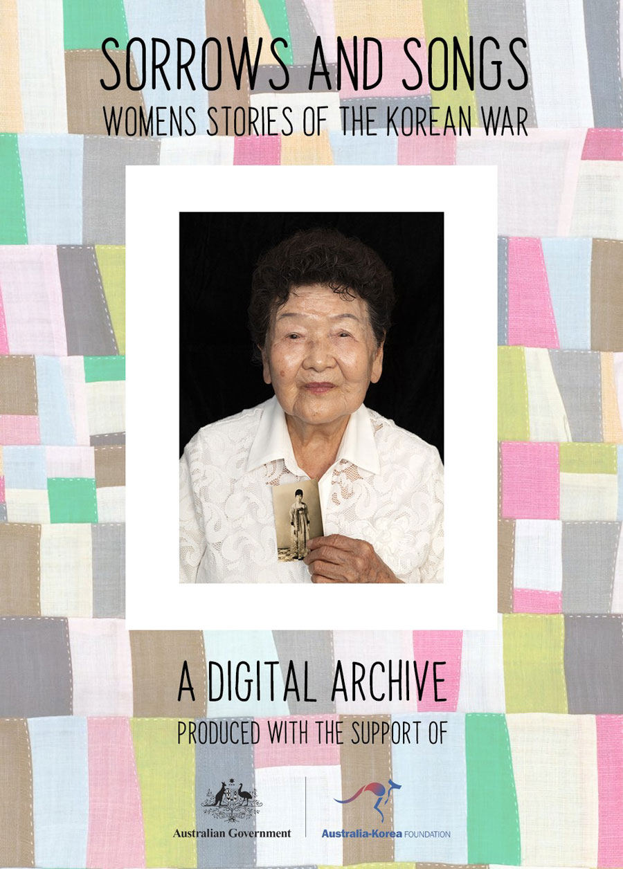 An elderly lady holding a photo of her younger self