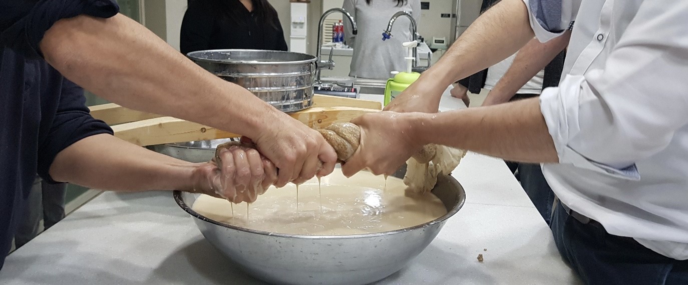 a photo of a team of people in the process of making fermented beverages. 