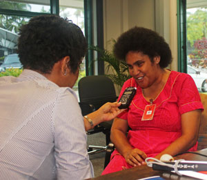 Sovaia Faktaufon speaks into a voice recorder being held by a female journalist