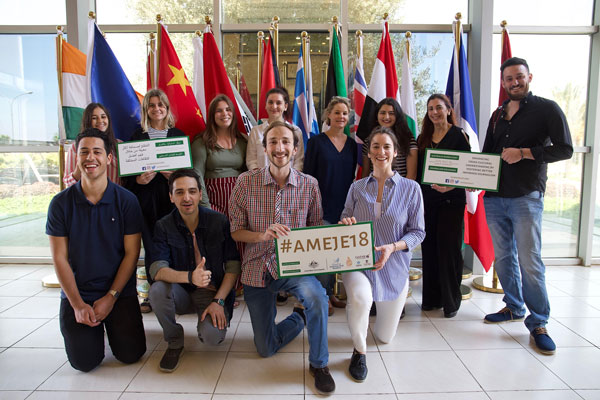 Group of people posing in front of flags