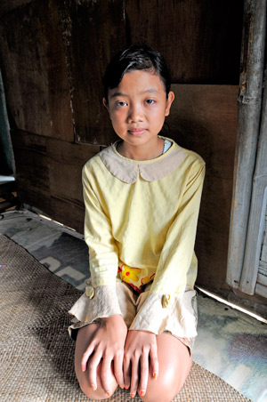 Photo of Anis kneeling on the floor