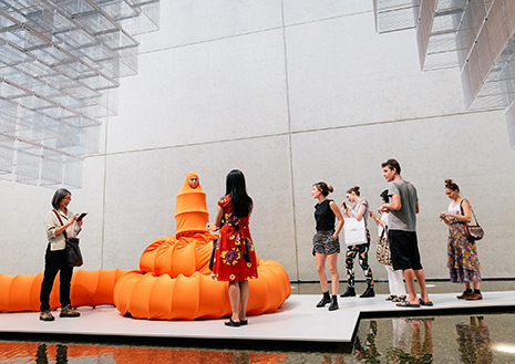 The Buddhist Bug 2015, Performance for APT8, QAGOMA, Brisbane, 21–22 November 2015. Orange lycra, wire, tube, thread, glue and two live bodies 