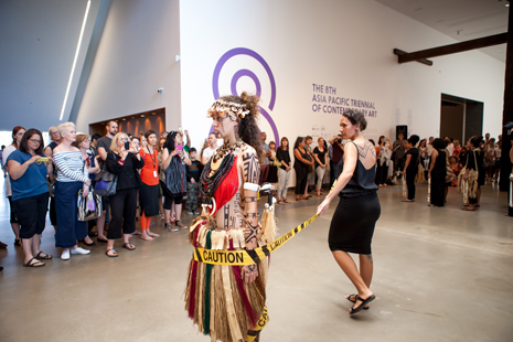 Two performers in front of a crowd