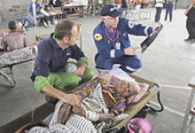 Two medical experts attend to victim on stretcher