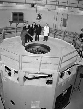 Scientist pointing out features of Lucas Heights nuclear reactor