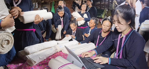 A group standing around fabric samples