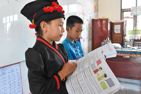 Two students reading textbooks
