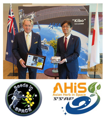 Photo of the Australian Ambassador H.E. Mr Richard Court AC presenting JAXA Vice President Mr Hiroshi Sasaki with 50g of Australian Golden Wattle Seeds.