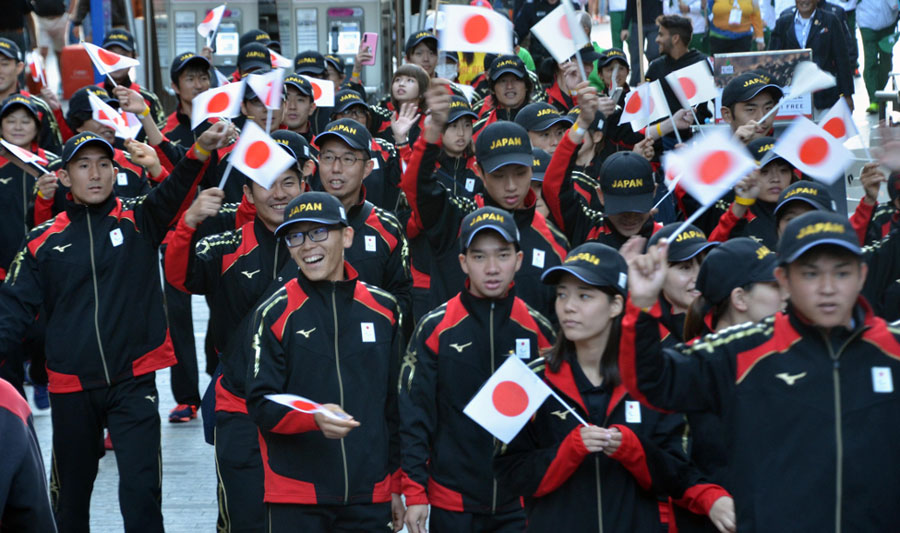 Photo of Team Japan holding the Japan flag at the Opening Ceremony of the 2019 INAS Global Games in Brisbane Australia.