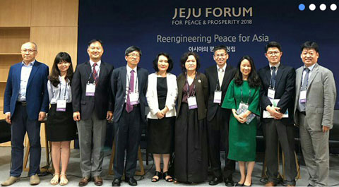 10 people standing infront of Reengineering Peace for Asia sign