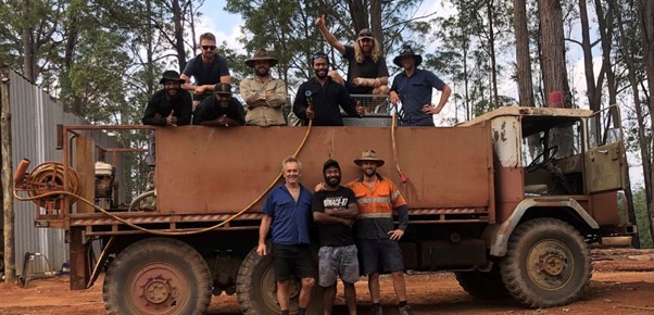 Group photo of PNG workers with Aussie farmer with a water truck during Australia's 2019 bushfire crisis.