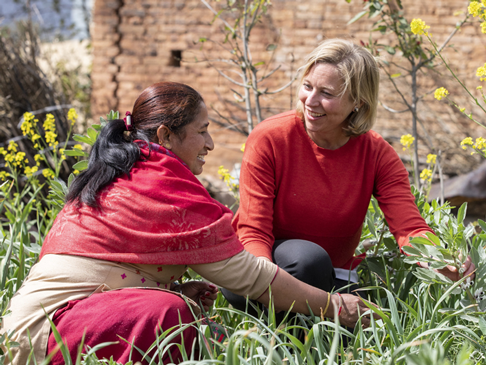 Two women sitting in a field