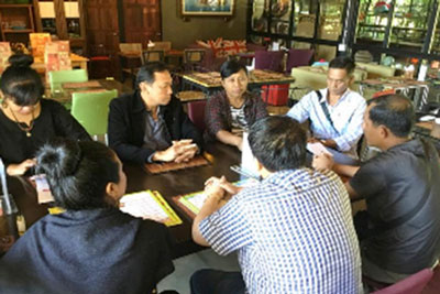 Seven people sitting around a table.