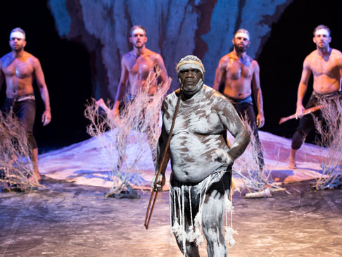 Abotiginal dancers on stage wearing traditional body paint