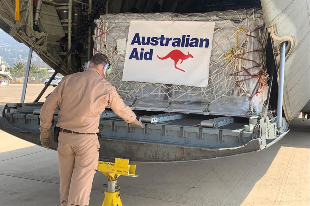 Australian Defence Force officer unloading supplies from the ADF C-130J Hercules aircraft.