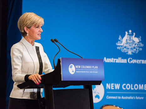 Minister Bishop talking at a podium