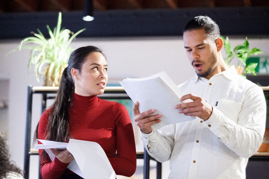 Photo of actors Tuakoi Ohia and Mark Coles Smith rehearsing their lines from script.