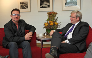 Minister Rudd and Bono sitting in armchairs