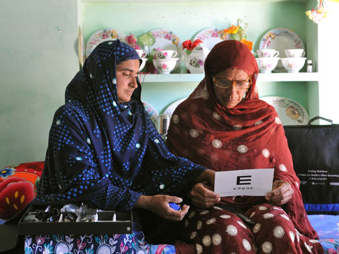 Shagufta and a friend with her eye examination kit.