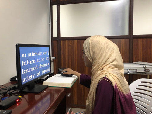 Photo of Amna on computer