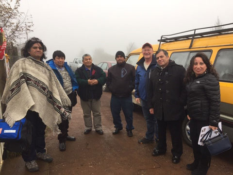 people posing for photo with Mapuche community leaders in a remote location