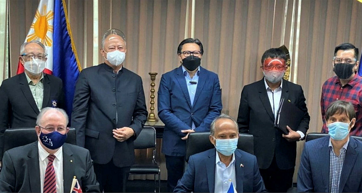 The group pose formally, wearing facemasks.