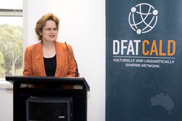 Frances Adamson speaking in front of a DFAT CALD banner