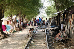 People sitting on a disused railway line in Cambodia